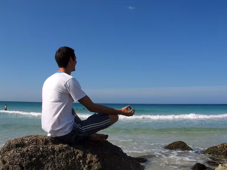 person practicing yoga in a serene natural setting, surrounded by lush greenery, with a sense of calm and healing